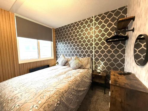 a bedroom with a bed and a window at Bayside in Bridlington
