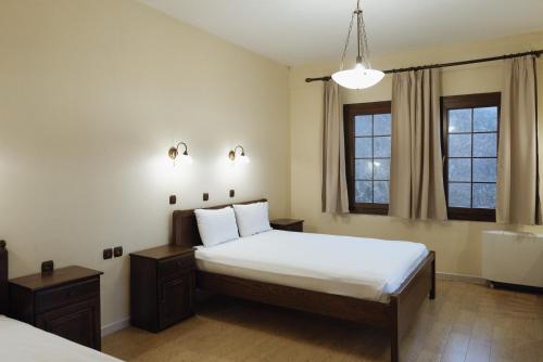 a hotel room with a bed and a window at Agnanti Hotel in Velventós
