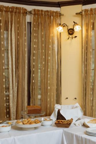 a table with plates of food on it at Agnanti Hotel in Velventós