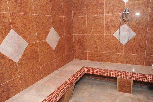 a bathroom with a shower with a bench in it at Rubezahl-Marienbad Luxury Historical Castle Hotel & Golf-Castle Hotel Collection in Mariánské Lázně
