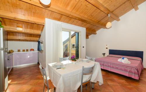 a dining room with a table and a bed at Le Tartarughe Aparthotel in Letojanni