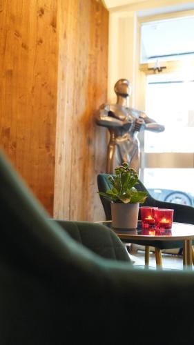 a room with a table with a potted plant on it at Amical Hotel Hagen in Hagen