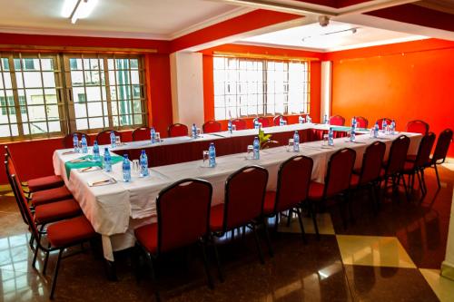 a long table in a room with red walls at Decasa Hotel in Nairobi