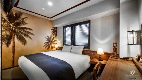 a bedroom with a bed and a desk and a window at DEL style Osaka Higashi Temma by Daiwa Roynet Hotel in Osaka