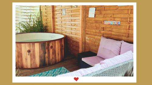 a room with a tub and a couch and a chair at Berghupferl-Alm mit Wellnessoase im Garten in Flintsbach am Inn