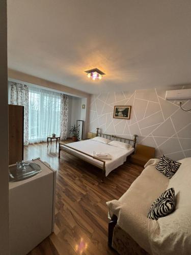 a room with two beds and a sink in it at Casa Ana in Eforie Nord