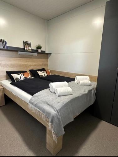 a bedroom with a large bed with two pillows at Forest House Razanac in Ražanac