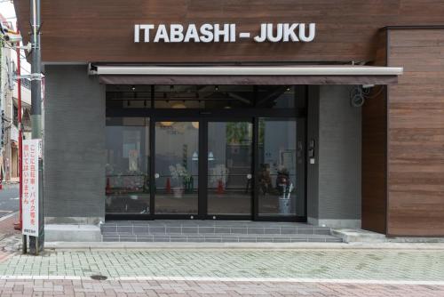 a building with a sign on the front of it at Tokyo Guest House Itabashi-juku in Tokyo
