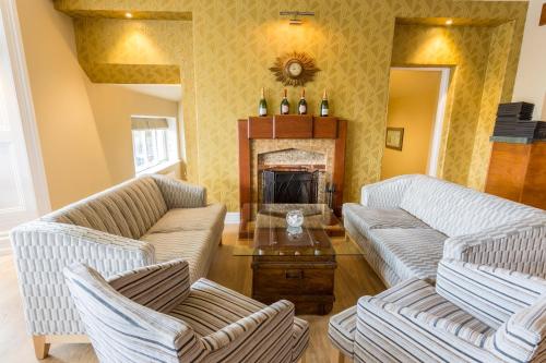 a living room with two couches and a fireplace at The Lamplighter Dining ~ Rooms in Windermere