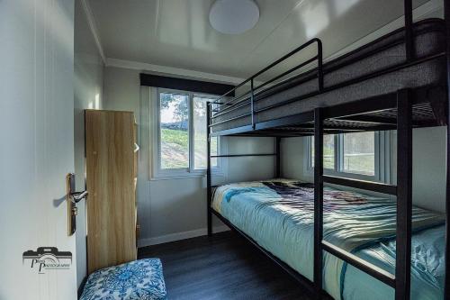 a bedroom with two bunk beds and a window at Timbuktoo Escape in Glen Creek