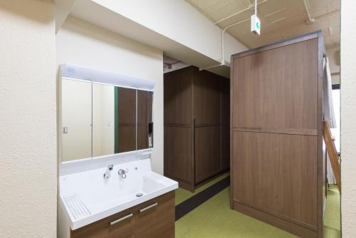 a bathroom with a sink and a mirror at Tokyo Guest House Itabashi-juku in Tokyo