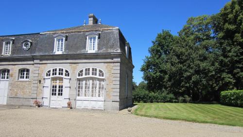an old stone building with a grassy yard at Holiday Home Château de Boucéel Mont Saint Michel in Vergoncey
