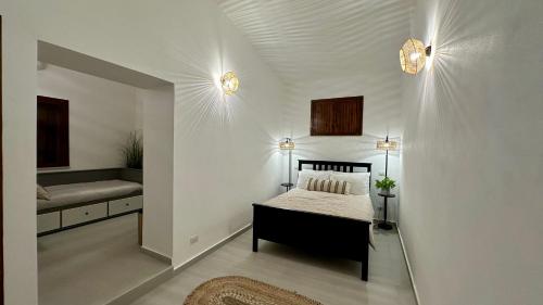 a bedroom with a bed and a bench in a room at Casa Manzella Apartments in Cinisi