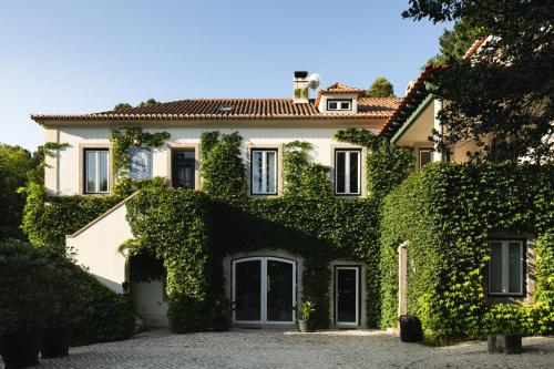 a large house with ivy on the side of it at Eighteen21 Houses - Quinta Velha in Sintra
