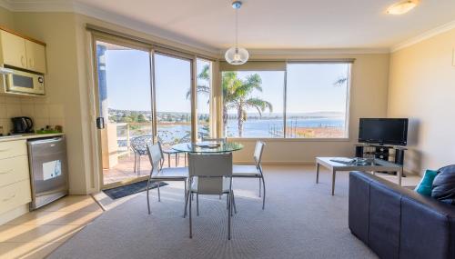 a kitchen and living room with a view of the ocean at The Bluff Resort Apartments in Encounter Bay