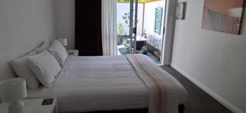 a bedroom with a large bed and a window at Spacious big sea views star bath in Paihia