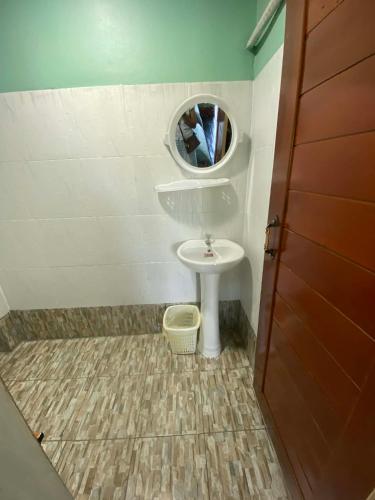 a small bathroom with a sink and a mirror at Don Det SODA RiverSide Guesthouse in Ban Donsôm Tai