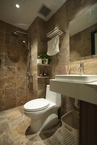 a bathroom with a toilet and a sink and a shower at Hanoi Aurelia Stay in Hanoi