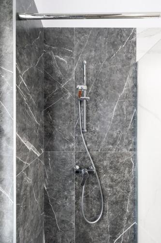 a shower with a glass door with a shower at Luxury Elegant Pipera New Apartment in Voluntari