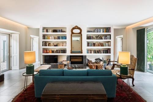 a living room with a blue couch and a fireplace at Eighteen21 Houses - Quinta Velha in Sintra