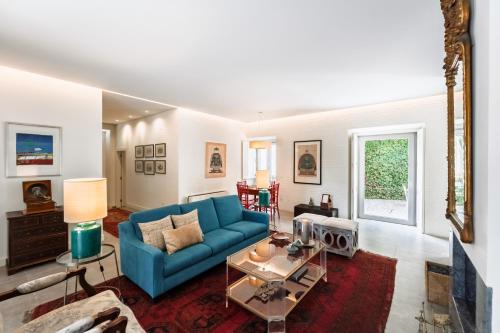 a living room with a blue couch and a table at Eighteen21 Houses - Quinta Velha in Sintra