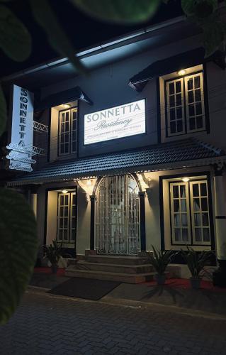 a building with a sign on the front of it at Sonnetta Residency in Cochin