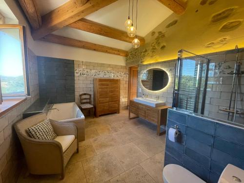 a large bathroom with a tub and a sink at Les Yourtes de Provence in Saint-Paulet-de-Caisson