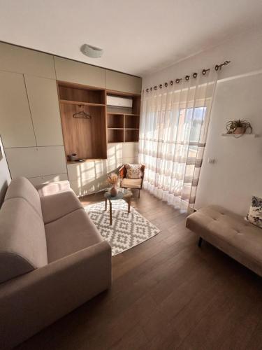 a living room with a couch and a chair at Boljevic Apartments in Bečići