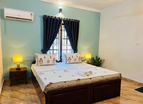 a bed in a room with a large window at Sonnetta Residency in Cochin