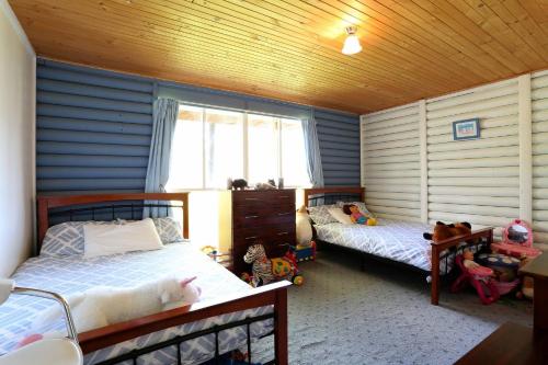 a bedroom with two beds and a window at Chloes Cabin Accommodation in White Beach