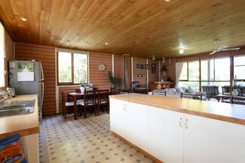 a kitchen and living room with a dining room at Chloes Cabin Accommodation in White Beach