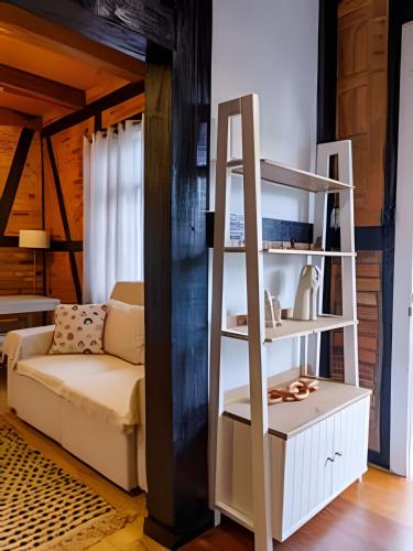 a living room with a book shelf and a couch at Casa Enxaimel em Pomerode SC 01 in Pomerode