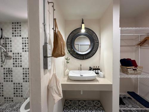 a bathroom with a sink and a mirror at Papa House Standard Zone A in Ban Bang Saen (1)