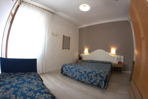 Postel nebo postele na pokoji v ubytování Hotel Moderno