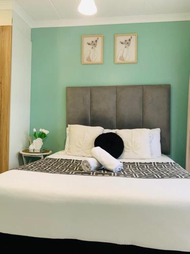 a bedroom with a large bed with two towels on it at The blyde-Luxury one bedroom apartment in Pretoria