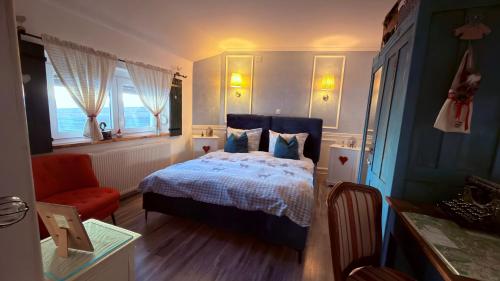 a bedroom with a bed and a chair and windows at Apartment Sabljaci by the Lake in Ogulin