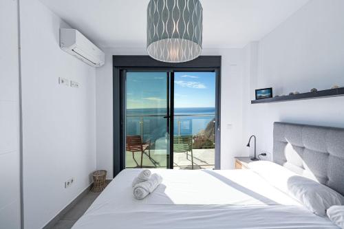 a bedroom with a bed with a view of the ocean at Terrazas de Ladera Duplex 7 Casasol in Nerja