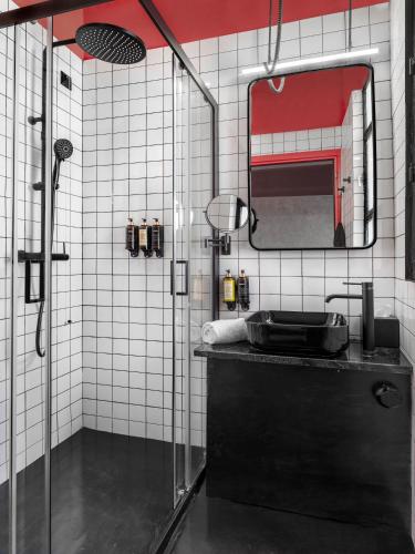 a bathroom with a shower with a sink and a mirror at Max Brown Hotel Downtown Part of Sircle Collection Formally known as Dave Red in Athens