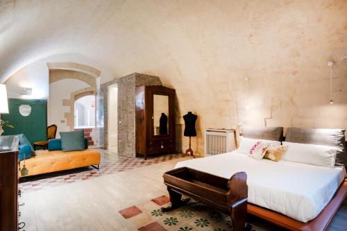 a bedroom with a bed and a living room at Suite San Pietro - Sassi di Matera in Matera