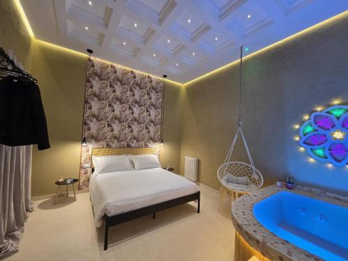 a bedroom with a bed and a bath tub at Erbanova al Borgo Suite in Taranto