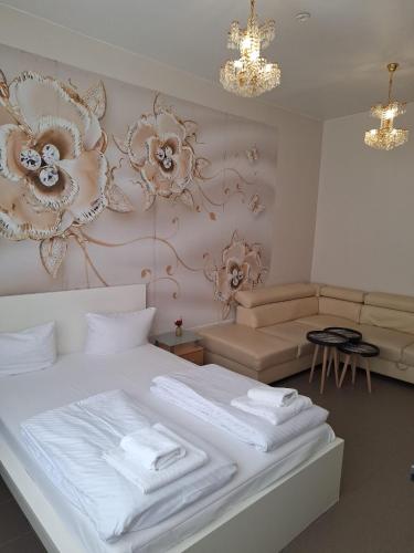 a bedroom with a white bed and a couch at Elifim in Berlin