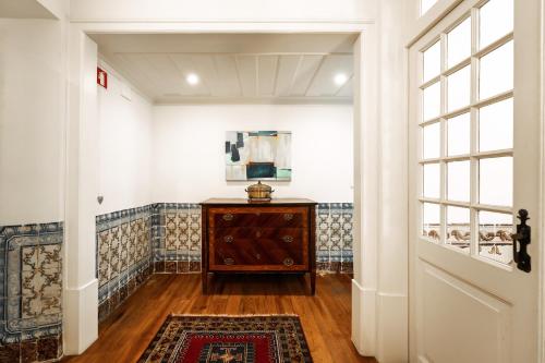 a hallway with a dresser and a window at Eighteen21 Houses - Casa de São Domingos in Lisbon