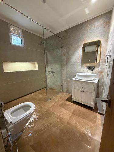 a bathroom with a toilet and a sink at Shobhalay- Premium 2BHK Parking prime location super interior in Rānchī