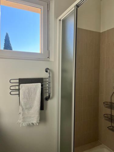 a towel hanging on a towel rack in a bathroom at La Bastide Tara in Cabriès
