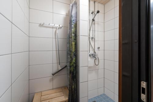 a bathroom with a shower with a plant at Hiisi Hostel Vihti - Private Rooms in Vihti