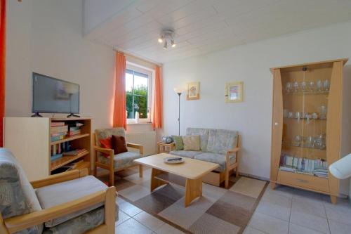 a living room with a couch and a table at STW24a Bungalow in Dorum-Neufeld