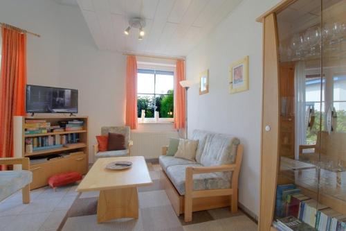 a living room with a couch and a table at STW24a Bungalow in Dorum-Neufeld