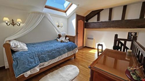 a bedroom with a blue bed with a canopy at Fayollas in Bussière-Galant