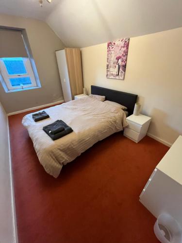 a bedroom with a bed with two towels on it at Station apartment in Llanberis