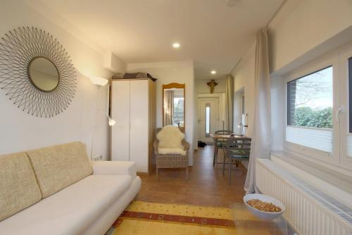 a living room with a white couch and a table at NS 6a Seestern Wremen in Wremen